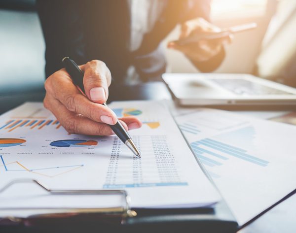 Business concept. Business people discussing the charts and graphs showing the results of their successful teamwork.